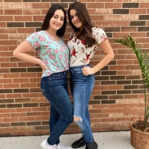 A teal blue v- neck tee with pink roses.